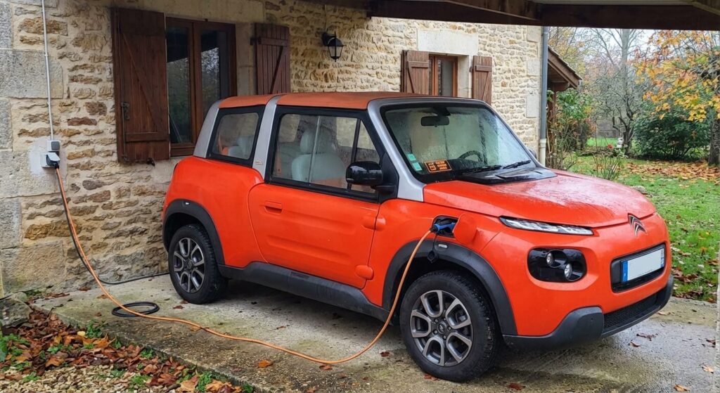 Véhicule de loisir Citroën E-Mehari électrique branché en permanence sur une prise domestique pour maintenir la chaleur de sa batterie